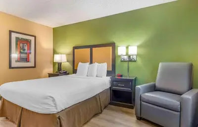 a hotel room with a bed and a chair at Extended Stay America Suites - Temecula - Wine Country in Temecula