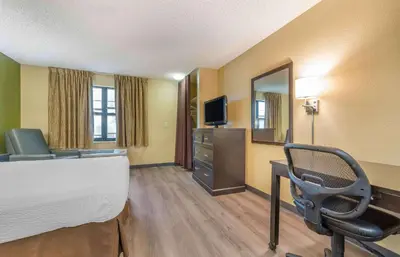 a hotel room with a bed and a desk and a chair at Extended Stay America Suites - Temecula - Wine Country in Temecula