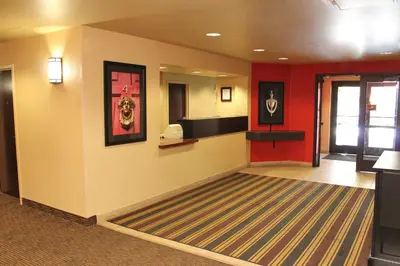 a lobby with a waiting room with red walls at Extended Stay America Suites - Temecula - Wine Country in Temecula
