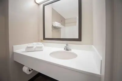 a white bathroom with a sink and a mirror at Extended Stay America Suites - San Diego - Mission Valley - Stadium in San Diego