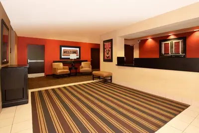 a lobby with red walls and a waiting room at Extended Stay America Suites - San Diego - Mission Valley - Stadium in San Diego