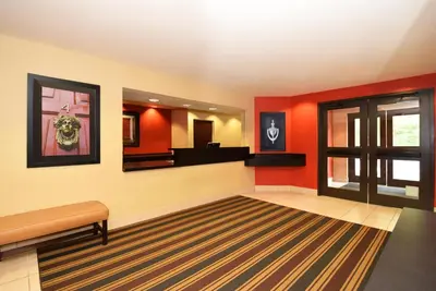 a waiting room with red walls and a mirror at Extended Stay America Suites - San Diego - Mission Valley - Stadium in San Diego