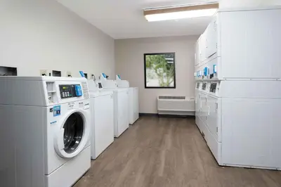 a laundry room with white washers and dryers at Extended Stay America Suites - San Diego - Mission Valley - Stadium in San Diego