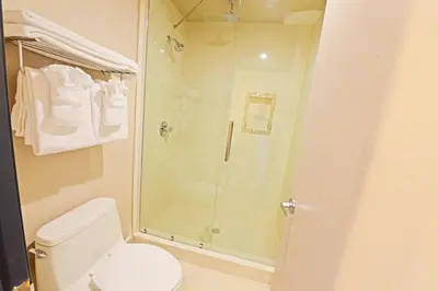 a bathroom with a shower and a toilet at Crescent Bay Inn in Laguna Beach