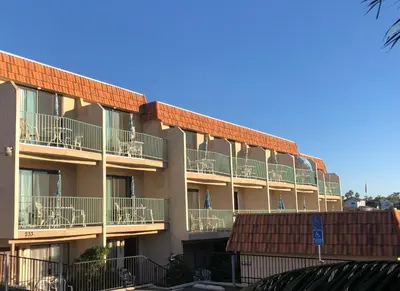 an apartment building with balconies on the side of it at Moonlight Beach Motel in Encinitas