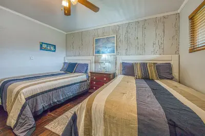 a bedroom with two beds and a ceiling at Heart of the Village in Carlsbad