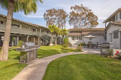 a backyard with a grill and a house at Heart of the Village in Carlsbad