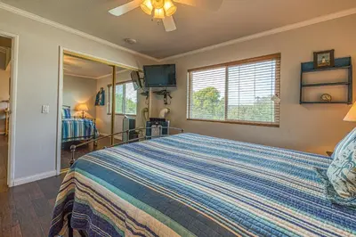 a bedroom with a bed and a television in it at Heart of the Village in Carlsbad