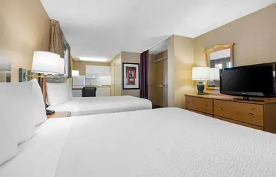 a hotel room with two beds and a flat screen tv at Extended Stay America Suites - San Diego - Fashion Valley in San Diego