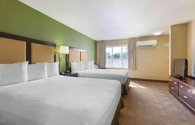 a hotel room with two beds and a television at Extended Stay America Suites - San Diego - Fashion Valley in San Diego