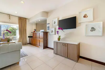 a living room with a couch and a flat screen tv at Best Western Downtown San Diego in San Diego