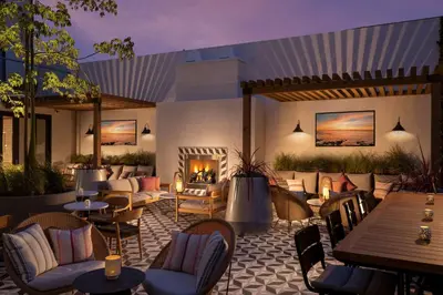 a restaurant with tables and chairs and a fireplace at The Monsaraz San Diego, Tapestry Collection By Hilton in San Diego