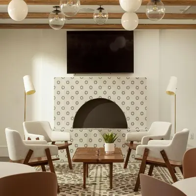 a living room with a fireplace and a tv at The Monsaraz San Diego, Tapestry Collection By Hilton in San Diego