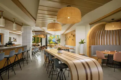 a restaurant with a long bar and chairs at The Monsaraz San Diego, Tapestry Collection By Hilton in San Diego