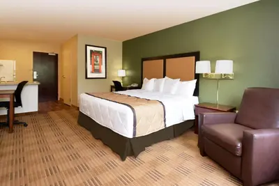 a hotel room with a bed and a desk and a chair at Extended Stay America Suites - Orange County - John Wayne Airport in Newport Beach