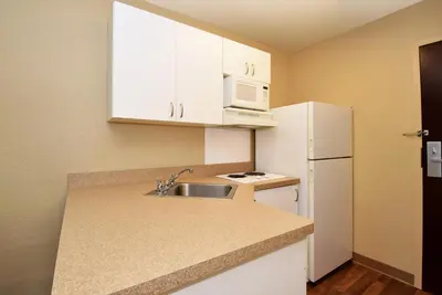 a small kitchen with a sink and a white refrigerator at Extended Stay America Suites - Orange County - John Wayne Airport in Newport Beach