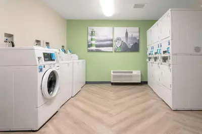 a laundry room with a washer and dryer at Extended Stay America Suites - Orange County - John Wayne Airport in Newport Beach