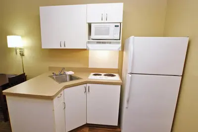 a kitchen with a white refrigerator and a sink at Extended Stay America Suites - Orange County - John Wayne Airport in Newport Beach