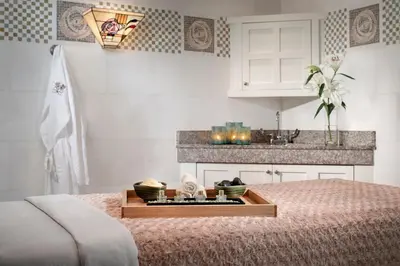 a bedroom with a tray of food on a bed at The Lodge at Torrey Pines in San Diego