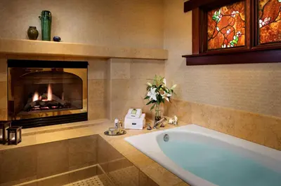 a bathroom with a bath tub and a fireplace at The Lodge at Torrey Pines in San Diego