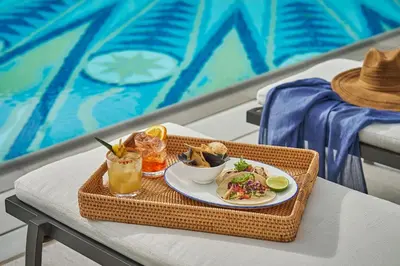 a tray with a plate of food on a table at Montage Laguna Beach in Laguna Beach