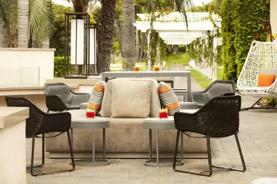 a patio with chairs and a couch on a patio at Hyatt Regency Newport Beach in Newport Beach