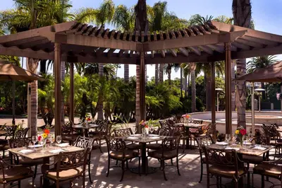 a group of tables and chairs under a pavilion at Hyatt Regency Newport Beach in Newport Beach