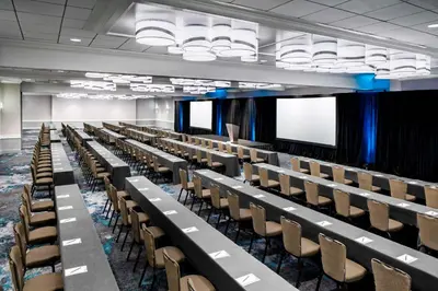 an empty lecture hall with rows of tables and chairs at Hyatt Regency Newport Beach in Newport Beach