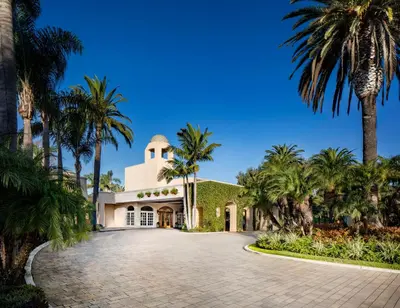 a driveway leading to a villa with palm trees at Hyatt Regency Newport Beach in Newport Beach
