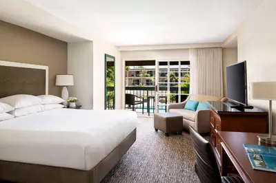 a hotel room with a bed and a desk and a couch at Hyatt Regency Newport Beach in Newport Beach