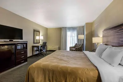 a hotel room with a bed and a flat screen tv at Quality Inn Fallbrook I-15 in Fallbrook