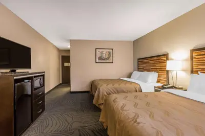 a hotel room with two beds and a flat screen tv at Quality Inn Fallbrook I-15 in Fallbrook