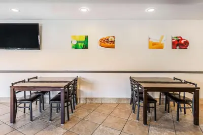 a dining room with tables and a tv at Quality Inn Fallbrook I-15 in Fallbrook