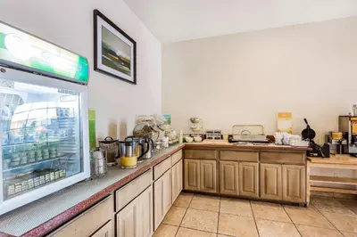 a kitchen with a counter and a refrigerator at Quality Inn Fallbrook I-15 in Fallbrook