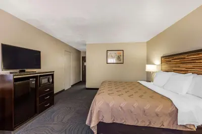 a hotel room with a bed and a flat screen tv at Quality Inn Fallbrook I-15 in Fallbrook