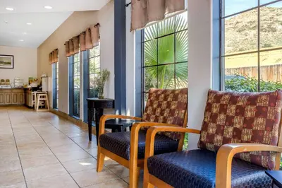 a living room with two chairs and a table at Quality Inn Fallbrook I-15 in Fallbrook