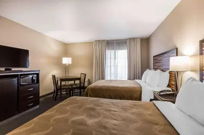 a hotel room with two beds and a desk at Quality Inn Fallbrook I-15 in Fallbrook