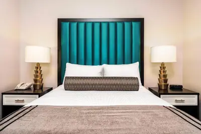 a bedroom with a bed with a green headboard at WorldMark San Diego - Balboa Park in San Diego