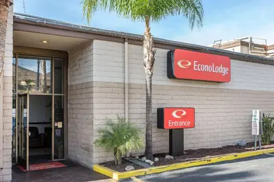 a building with a palm tree in front of it at Econo Lodge Lake Elsinore Casino in Lake Elsinore