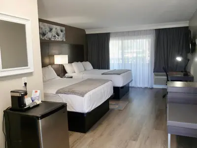 a hotel room with two beds and a kitchen at Econo Lodge Lake Elsinore Casino in Lake Elsinore