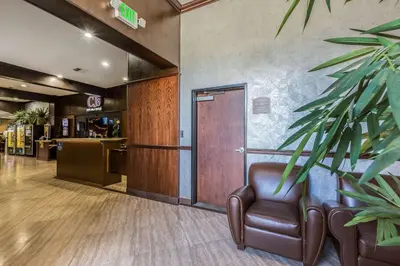 a lobby with a leather chair and a door at Econo Lodge Lake Elsinore Casino in Lake Elsinore
