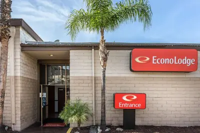 a building with a palm tree in front of it at Econo Lodge Lake Elsinore Casino in Lake Elsinore