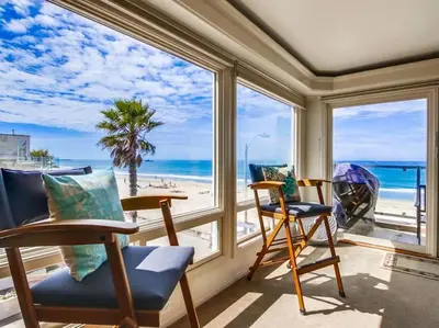 a room with two chairs and a view of the beach at Luxury Penthouse with Elevator - Sleeps 10+ - Family Friendly Sun / Surf / Sand in San Diego