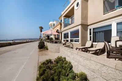 a building with chairs and tables next to a street at Luxury Penthouse with Elevator - Sleeps 10+ - Family Friendly Sun / Surf / Sand in San Diego