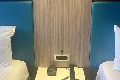 a room with two beds and a phone on a table at Super 8 by Wyndham Oceanside Downtown in Oceanside