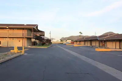 an empty street in a small town with buildings at Menifee Inn in Menifee