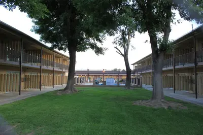 a row of trees in front of a building at Menifee Inn in Menifee