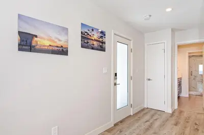a white room with two pictures on the wall at Ocean Villas Beach Front in Carlsbad