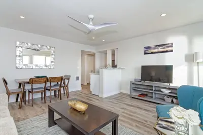 a living room with a couch and a table at Ocean Villas Beach Front in Carlsbad