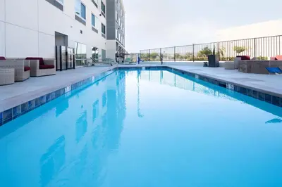 a swimming pool with blue water in a building at Holiday Inn Express & Suites - Murrieta by IHG in Murrieta